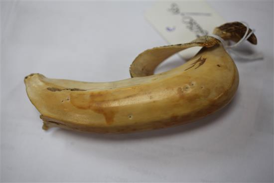 A Japanese ivory model of a partially peeled banana, early 20th century, 4.5cm, unsigned, re-glued section to tip